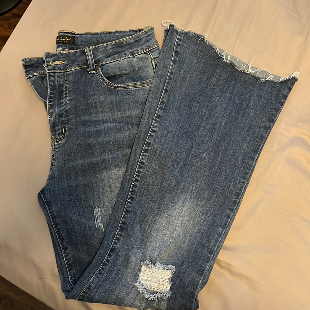 Not sure of the brand. Womens distressed flare jeans size 9.